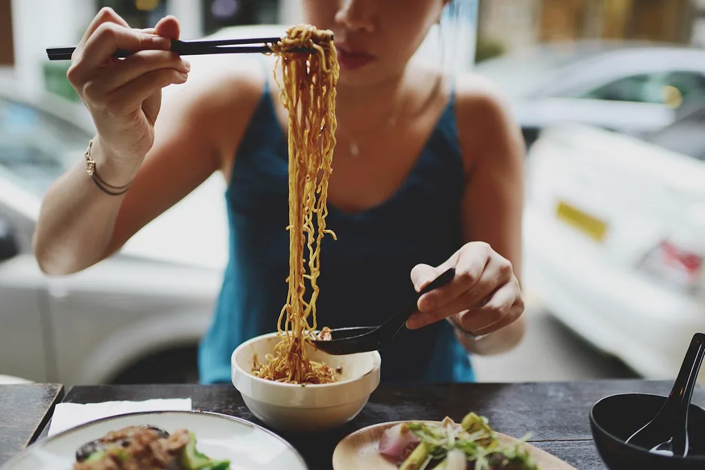 woman eating noodles