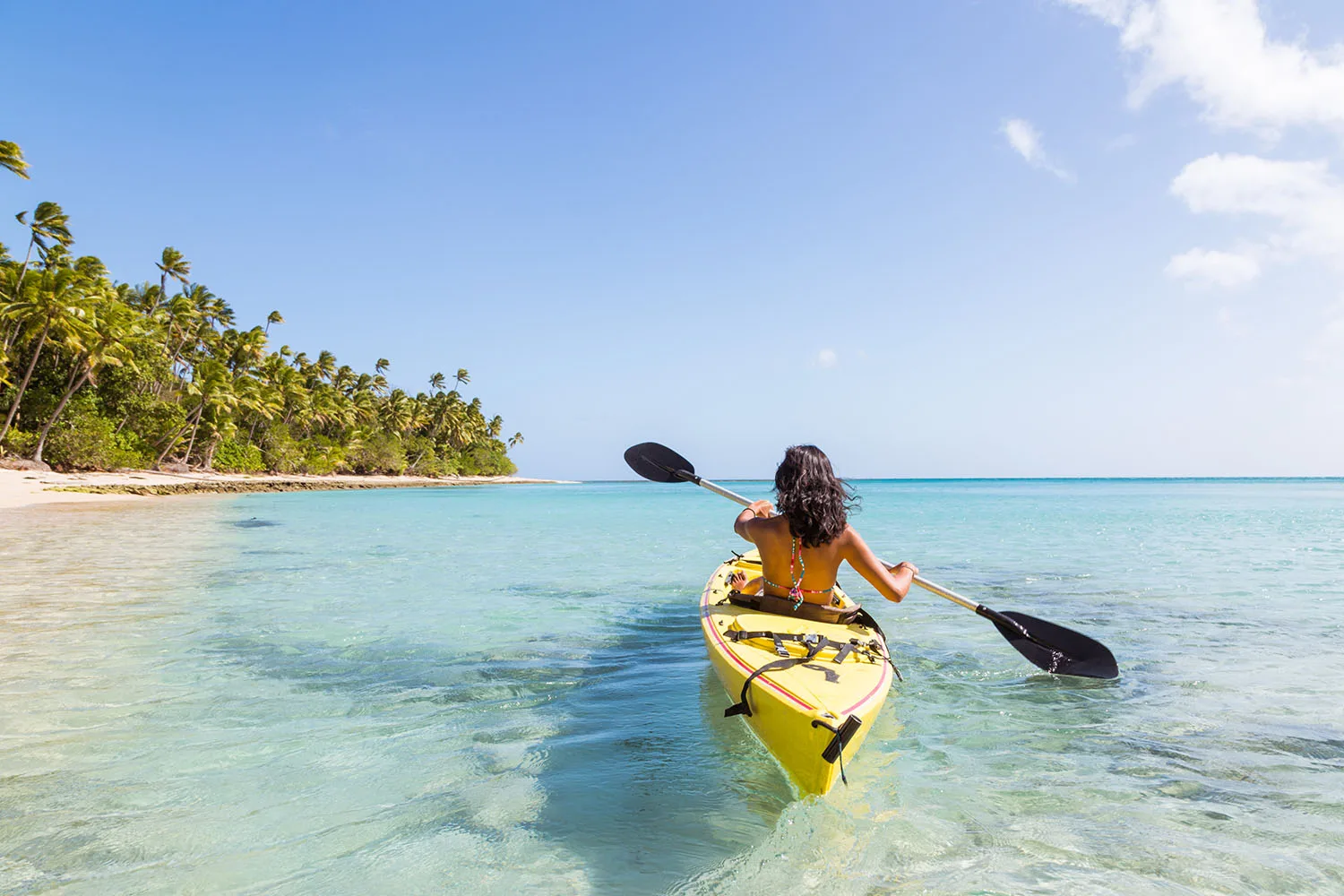 woman kayaking in tropical waters