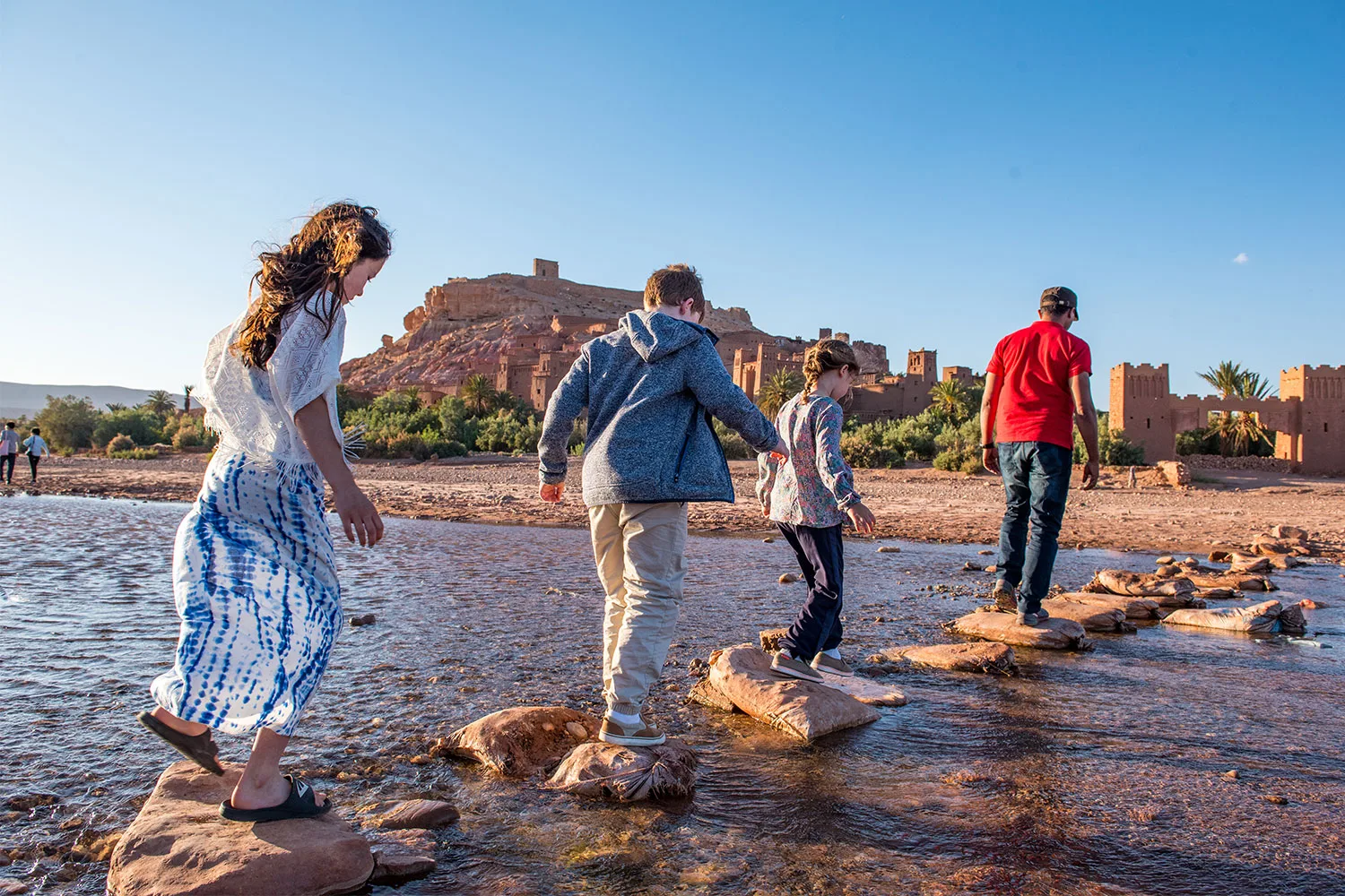 Family crossing river