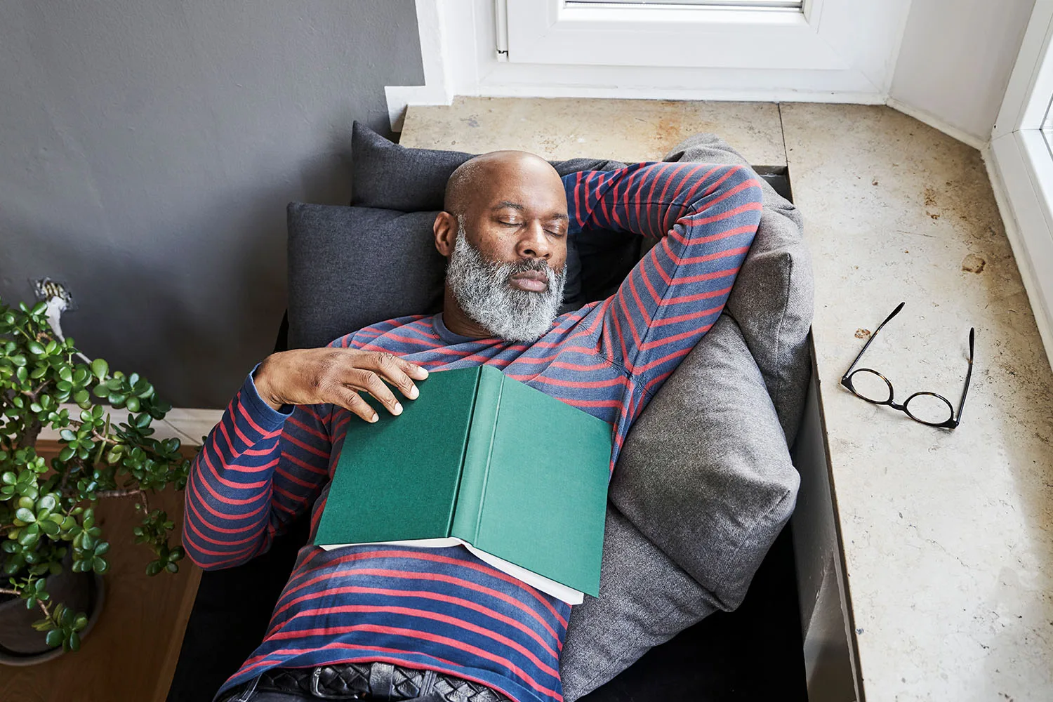 man sleeping with book on belly