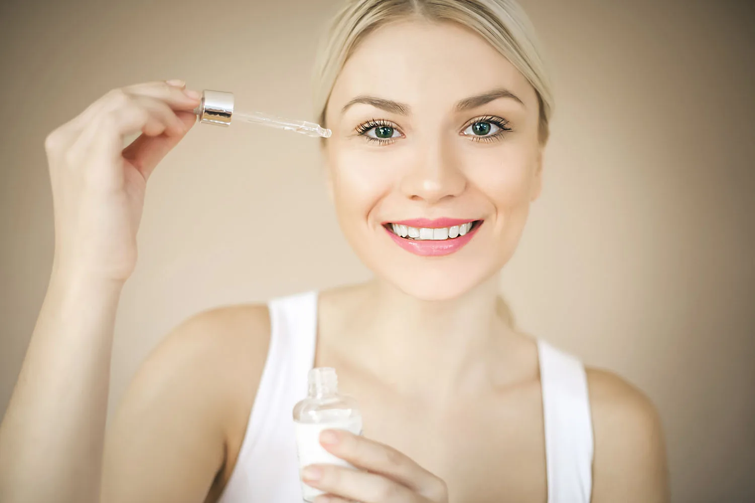 woman applying product to face