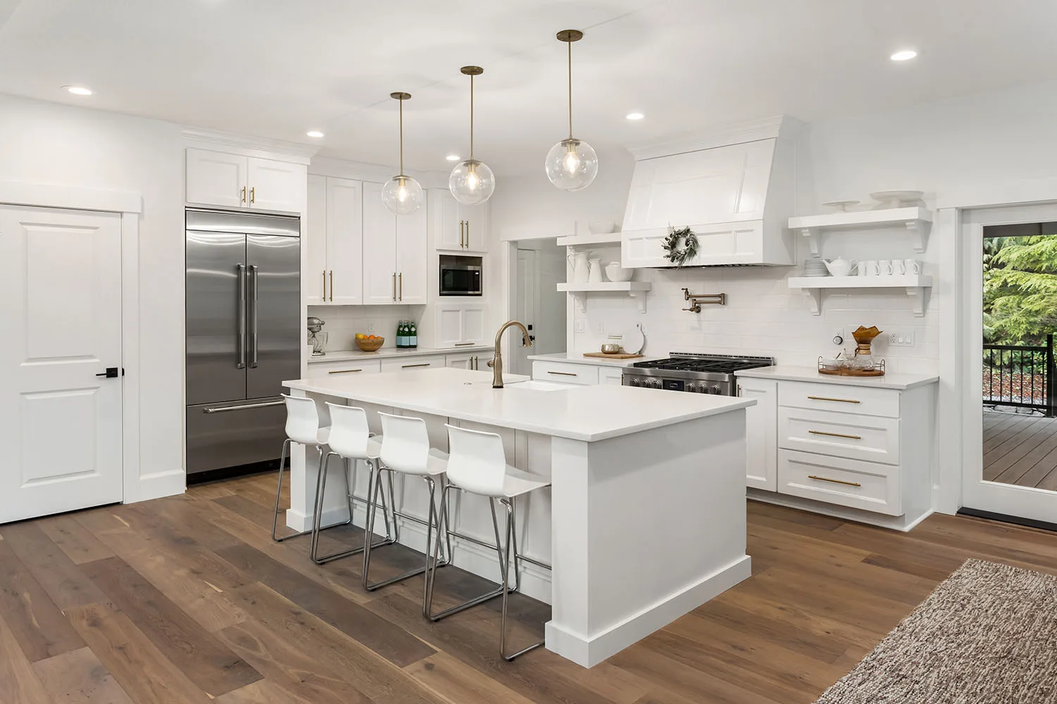 all white traditional kitchen with pendant lights and kitchen island bar stools breakfast bar