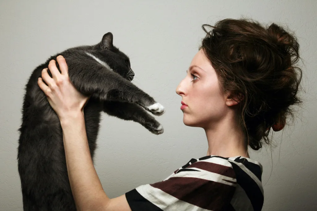 woman holding cat up