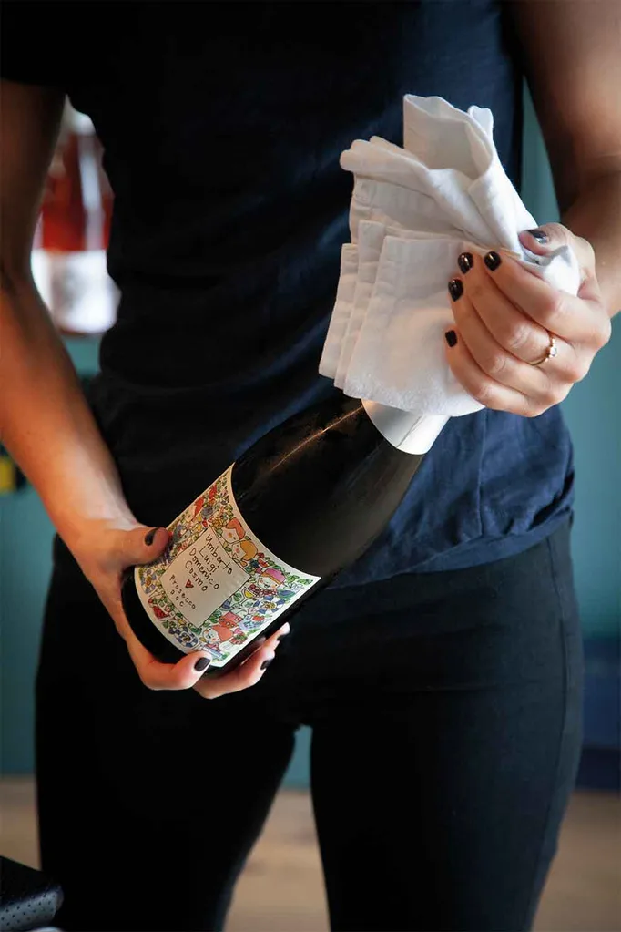 Holding bottle of prosecco