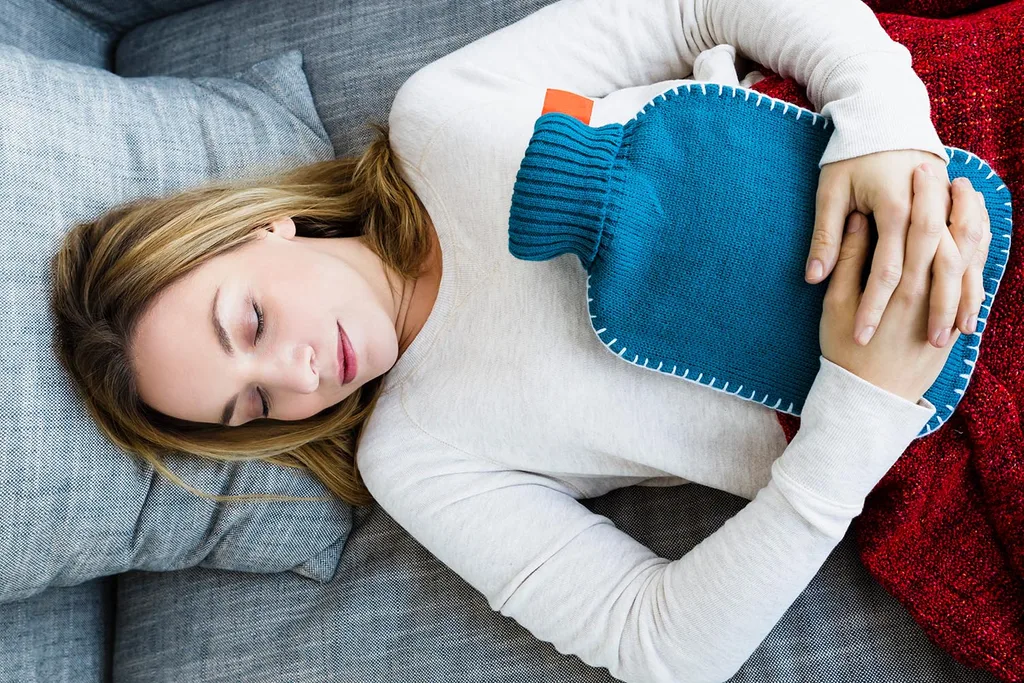 woman holding hot water bottle