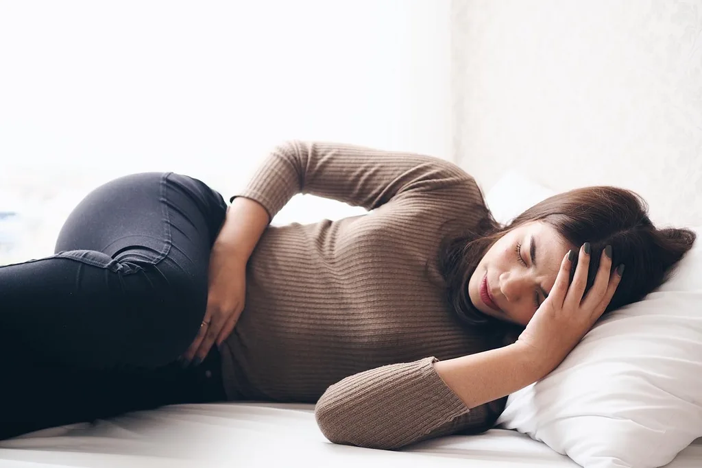 woman laying down on bed