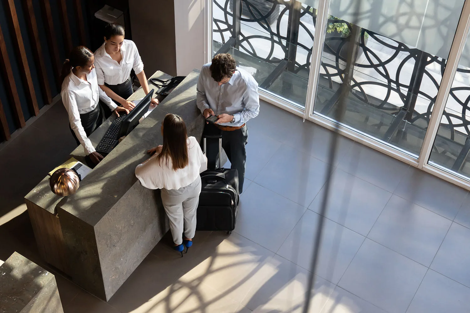 couple standing at hotel check in desk
