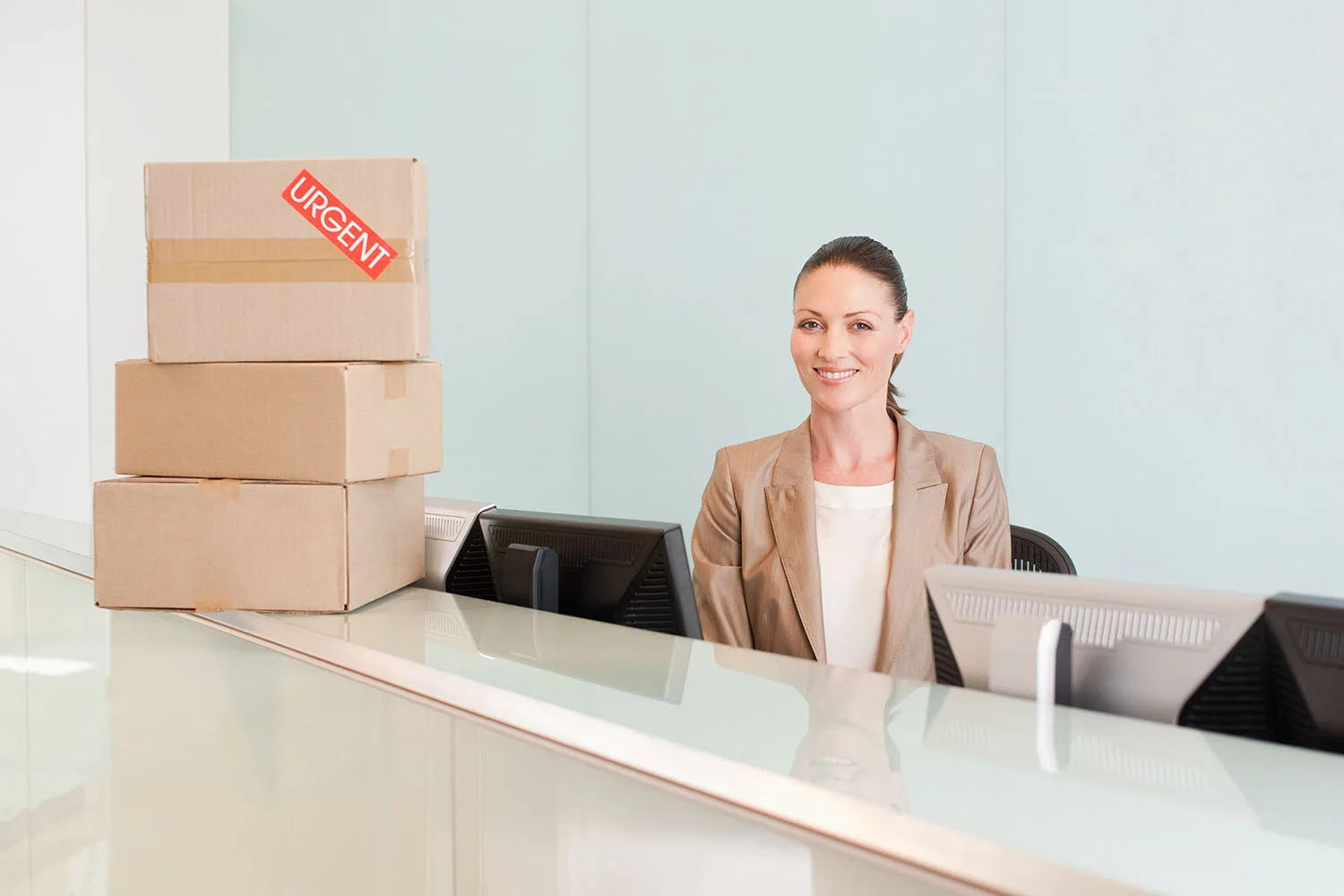 women behind desk that has packages on it