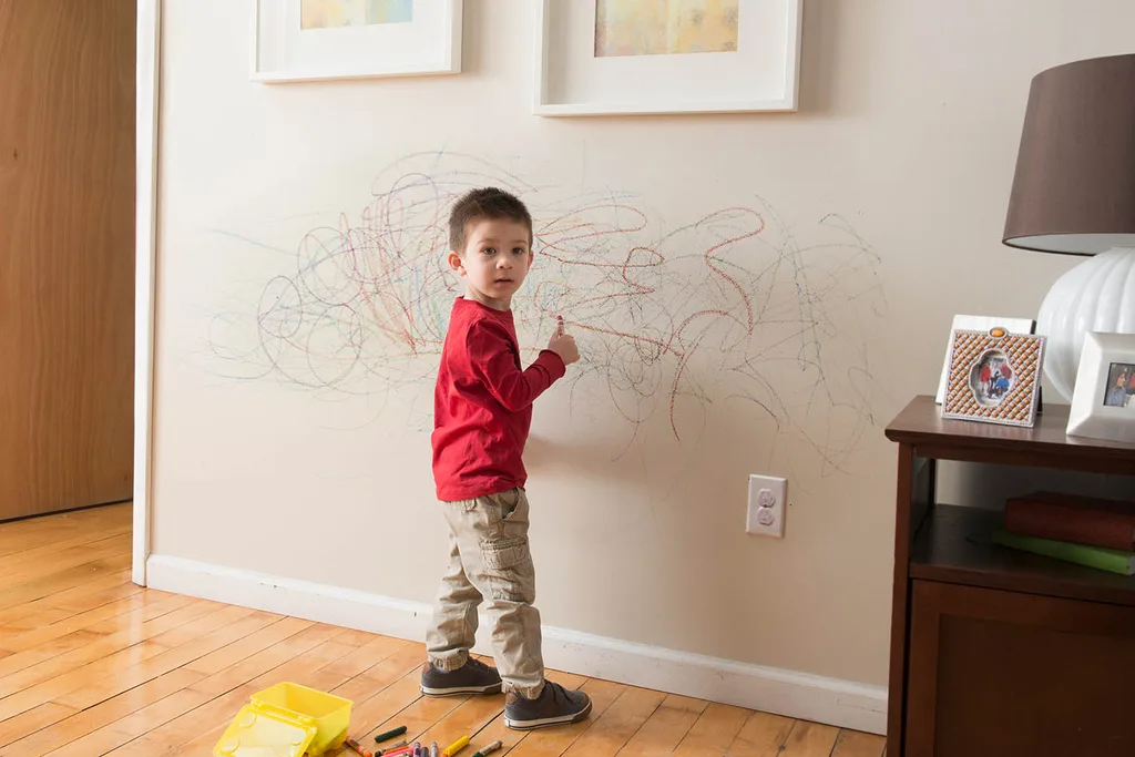 kid drawing on wall