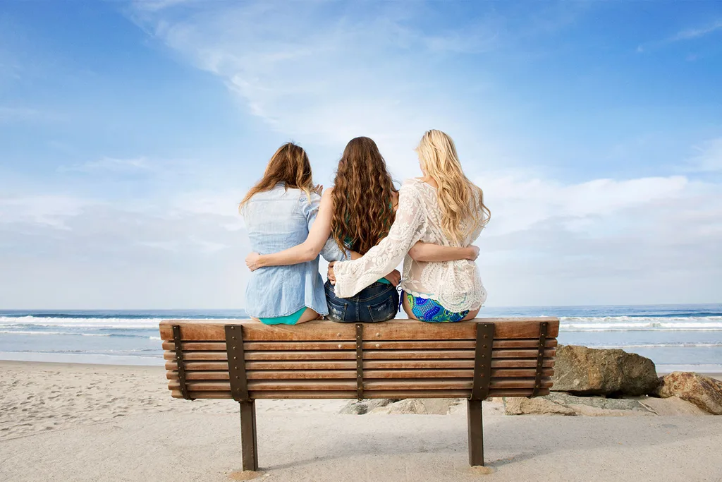 Three women sitting on bench