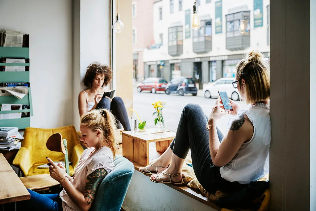 three girls on their phones