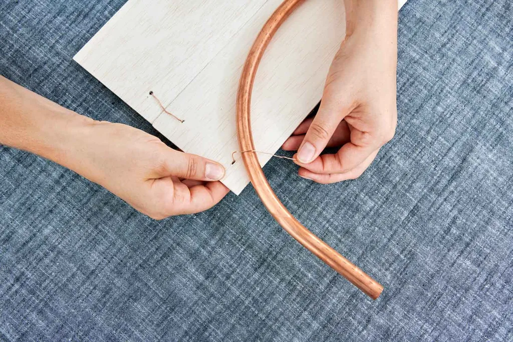 Tie copper coil to balsa wood