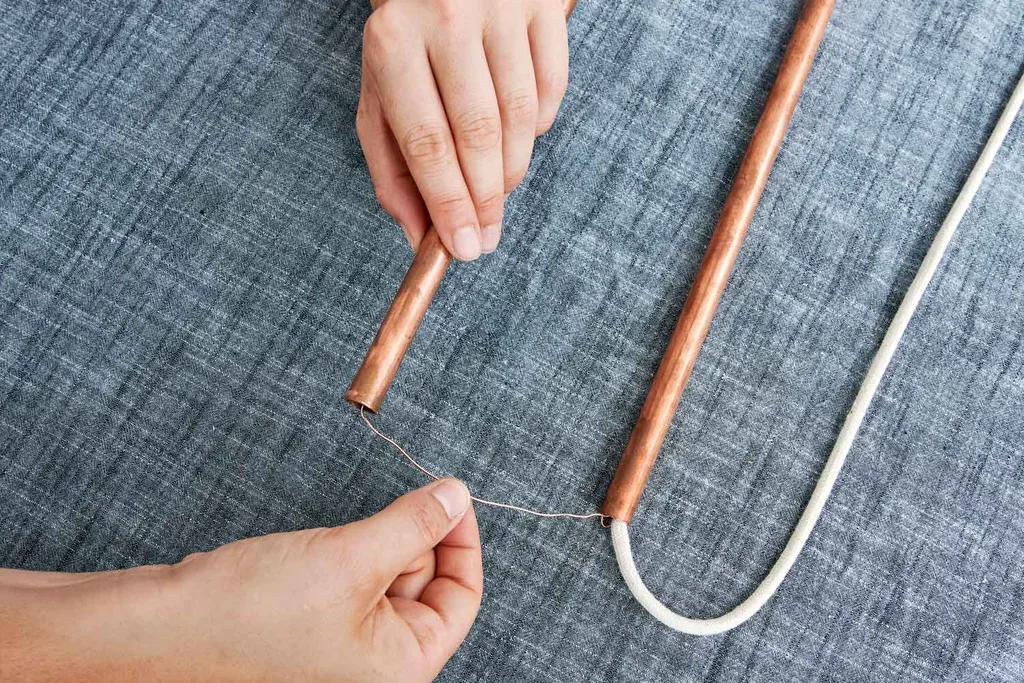 Hang copper pipes on cord