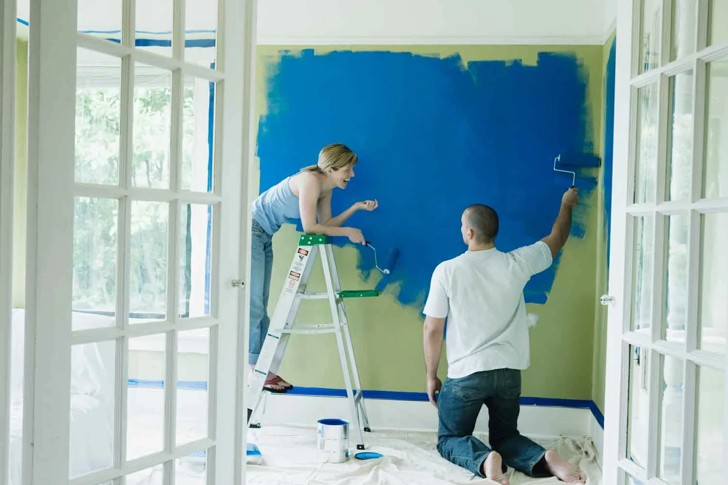 Couple painting a room