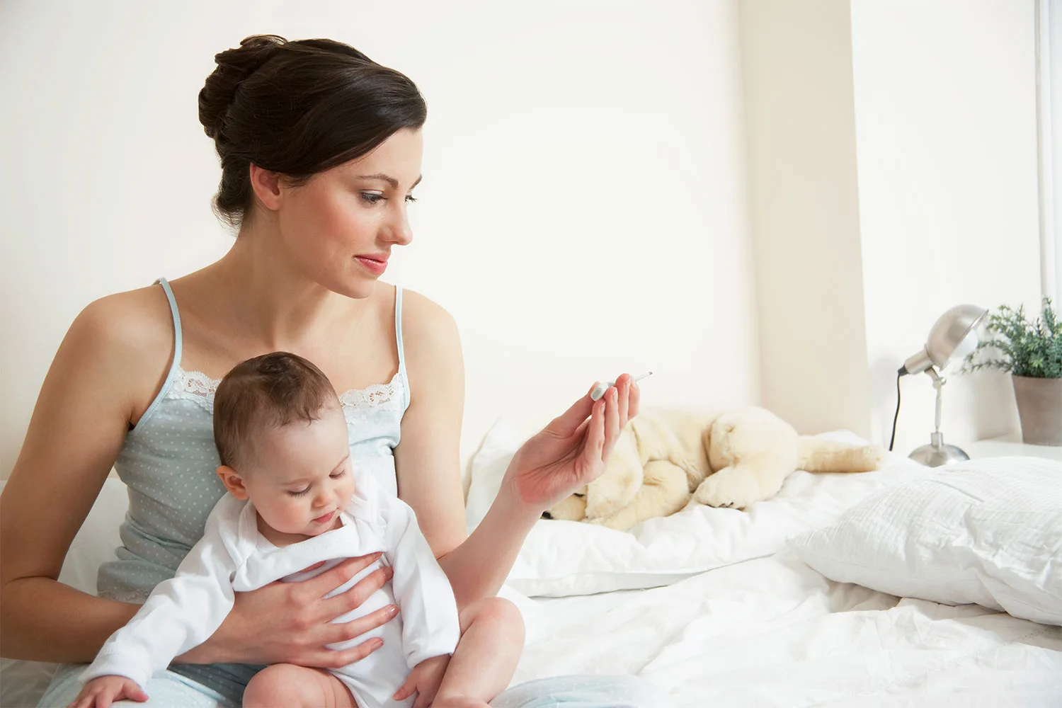 Mum and baby looking at thermometer