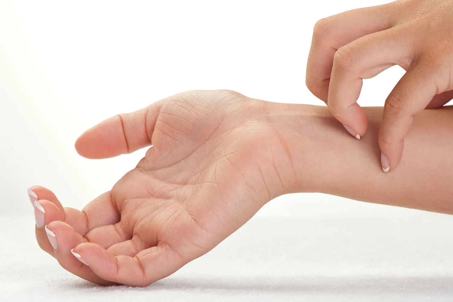 scratching wrist