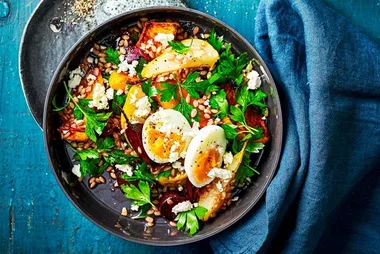 barley salad with boiled eggs on top