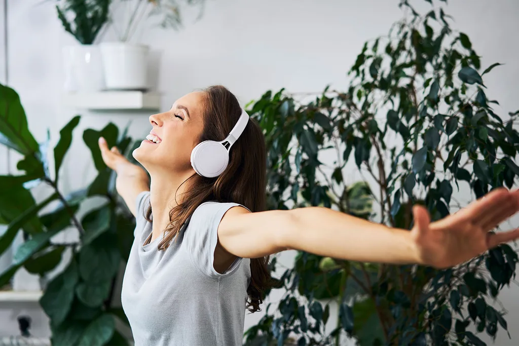Woman dancing with headphones on.