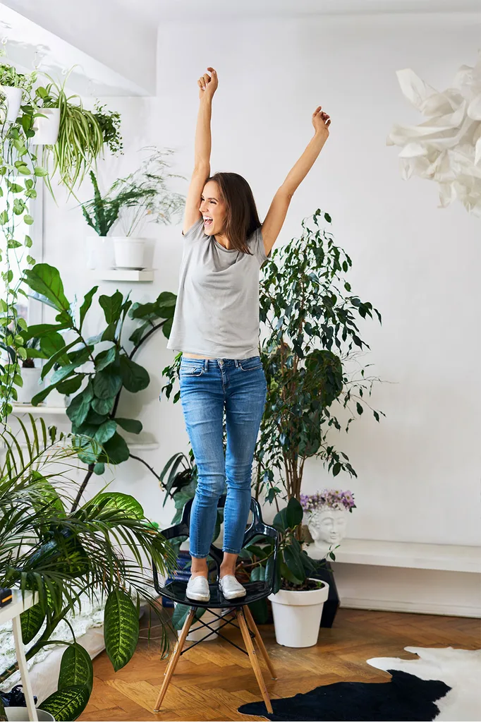 Woman excited in room with plants