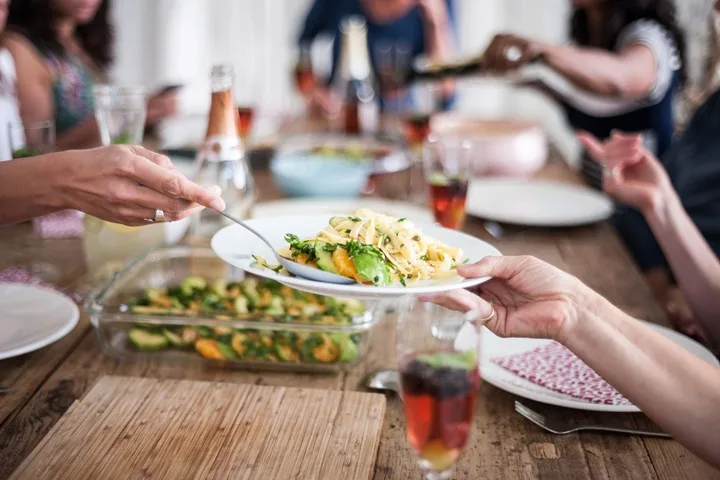 People eating food around table
