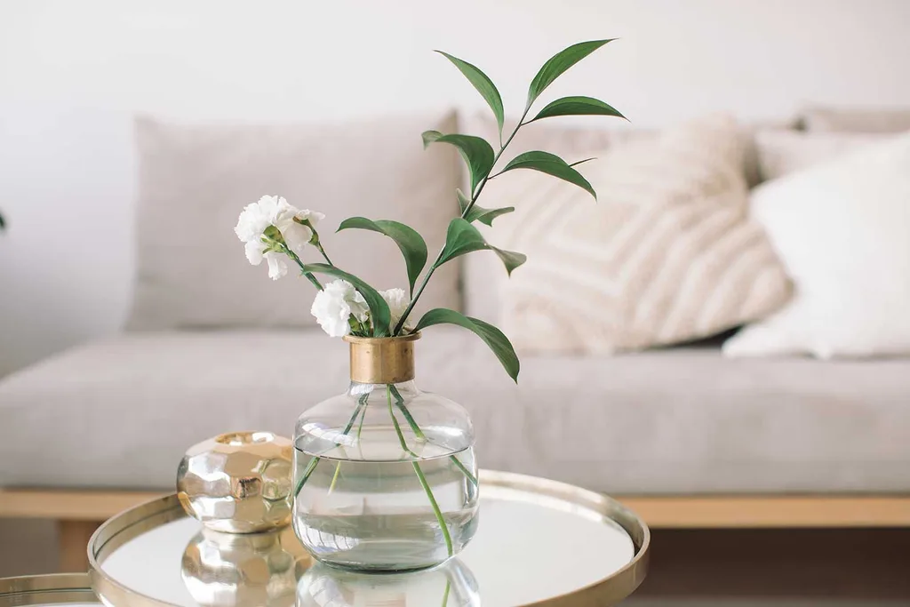 Sofa with vase of flowers on coffee table
