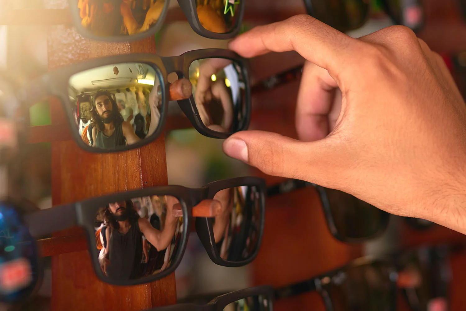 hand touching sunglasses