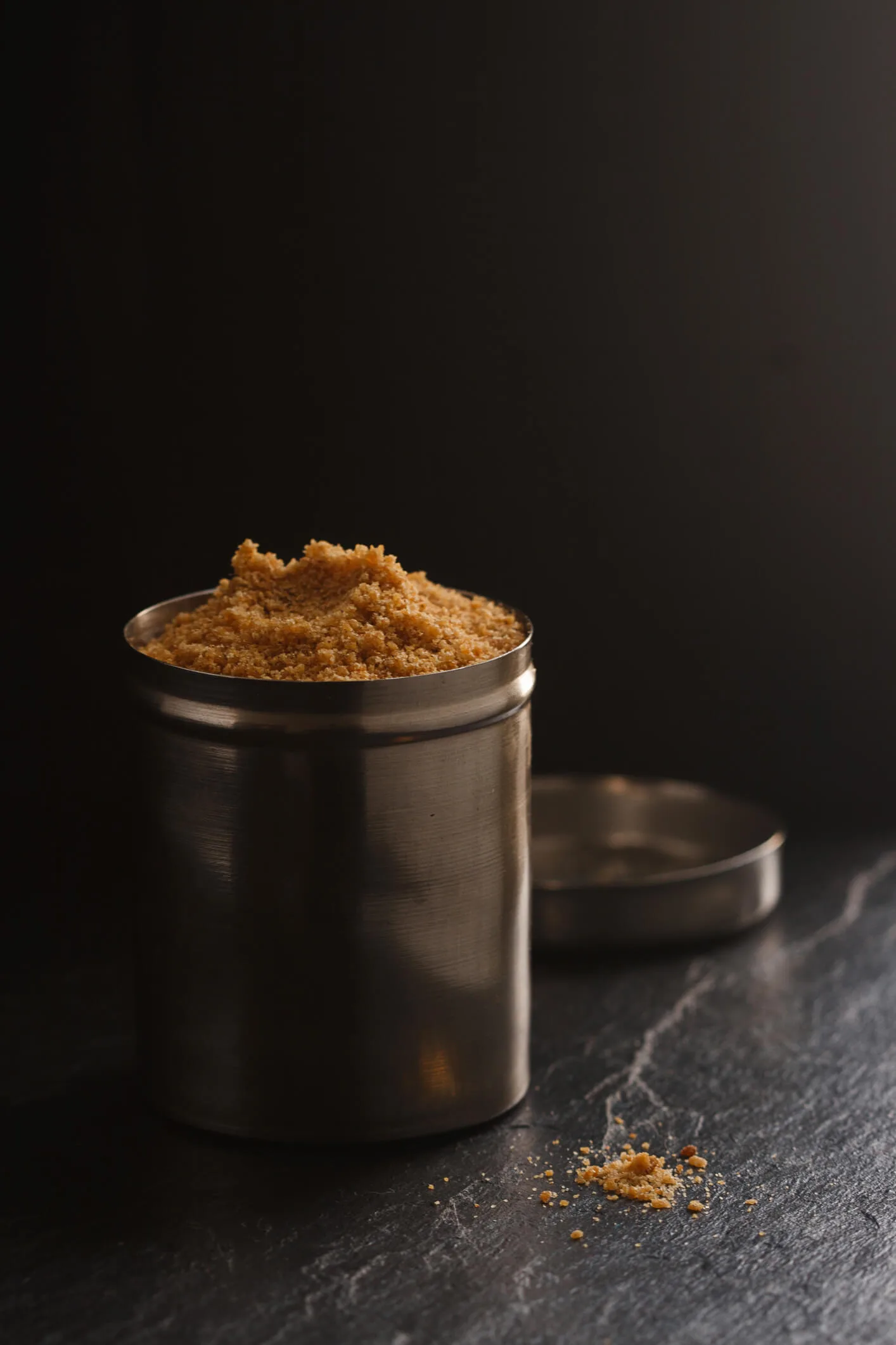 Asafoetida in a metal cylindrical container