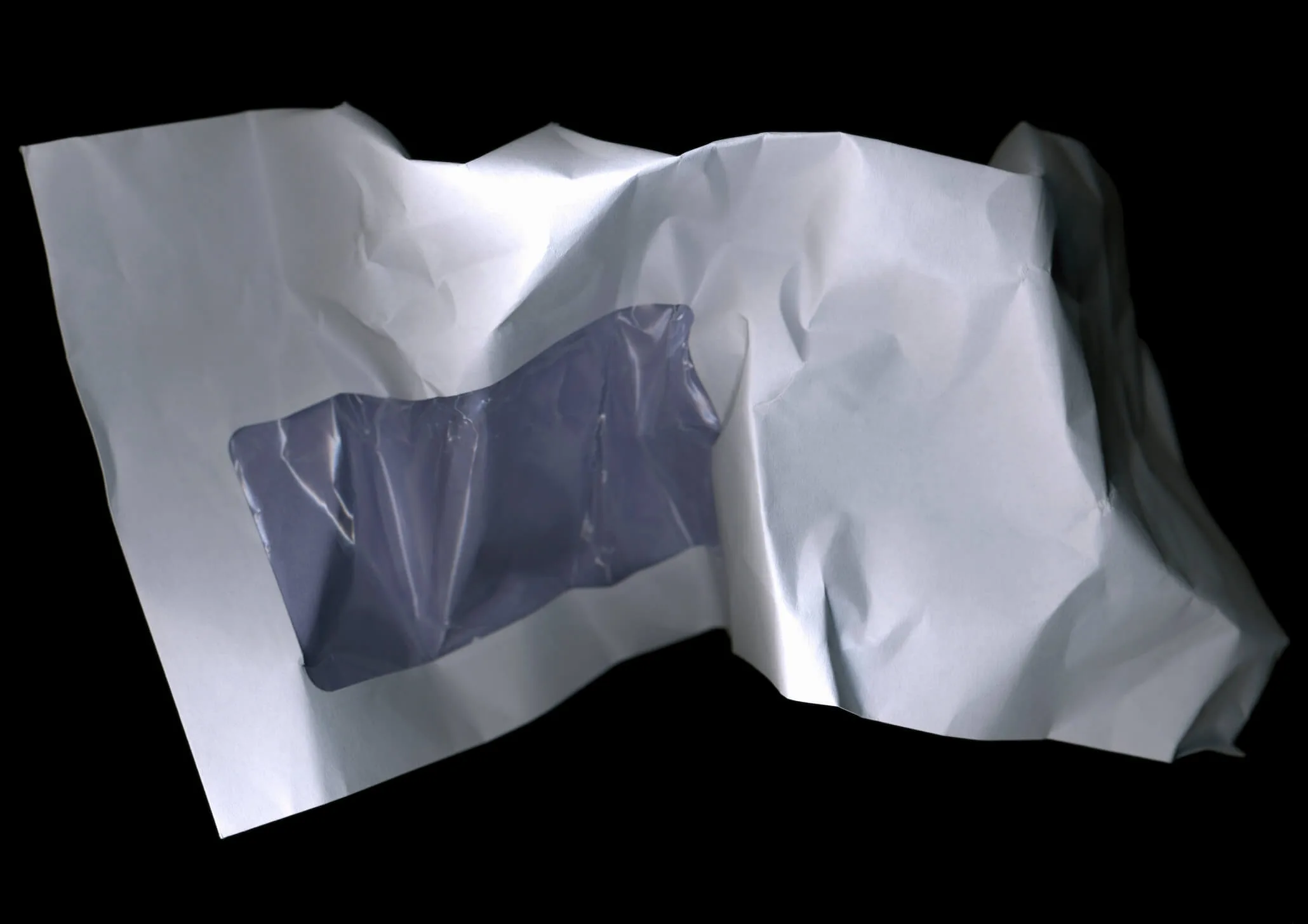 A crumpled envelope on a black background