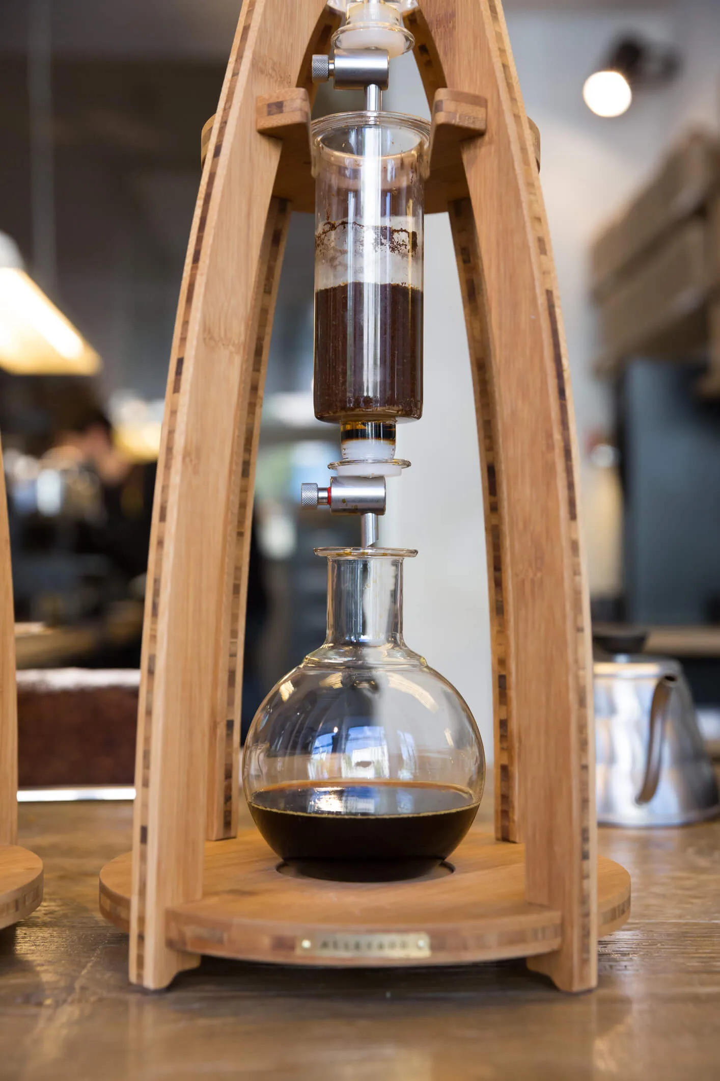 A cold drip coffee maker with dark coffee brewing