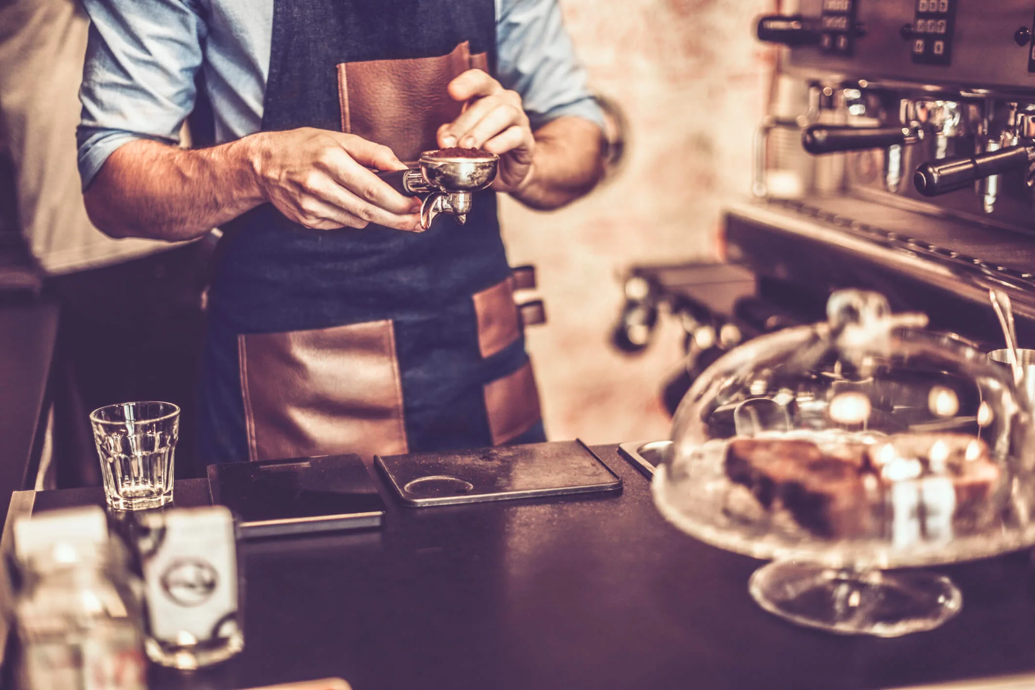 A barista making coffee in a cafe