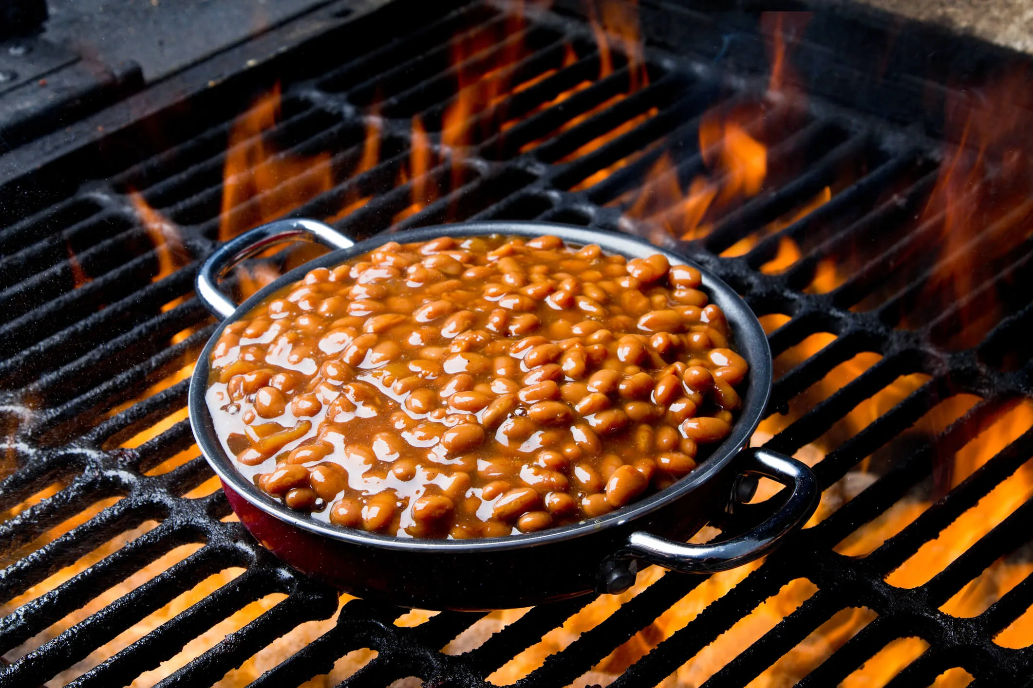 Baked beans grilling over a fire