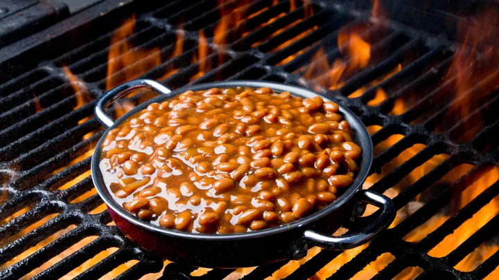 Baked beans grilling over a fire