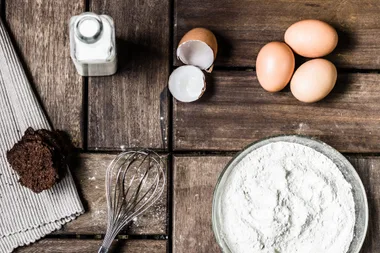 Cake ingredients on a wooden table