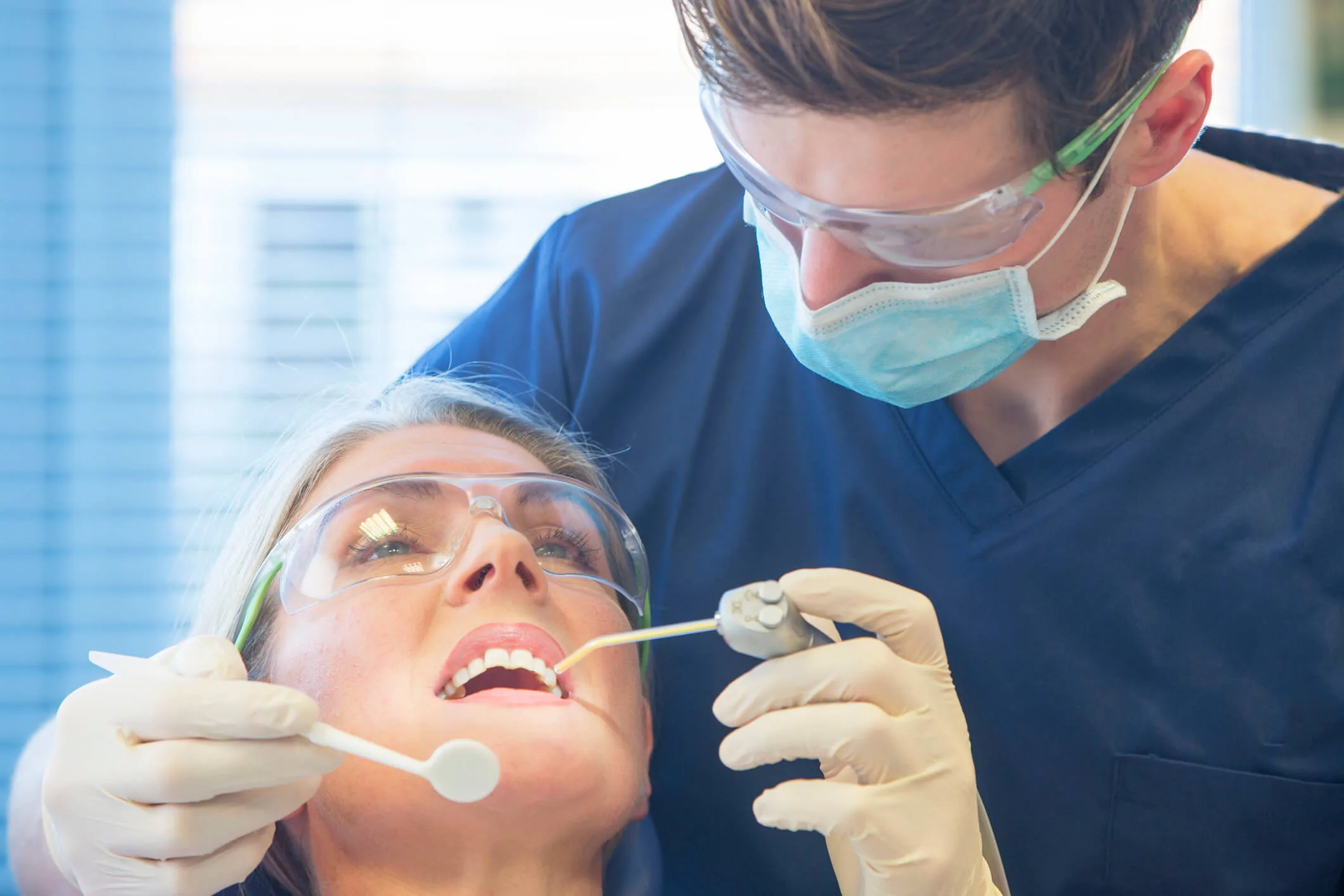 A dentist examining a patient's teeth