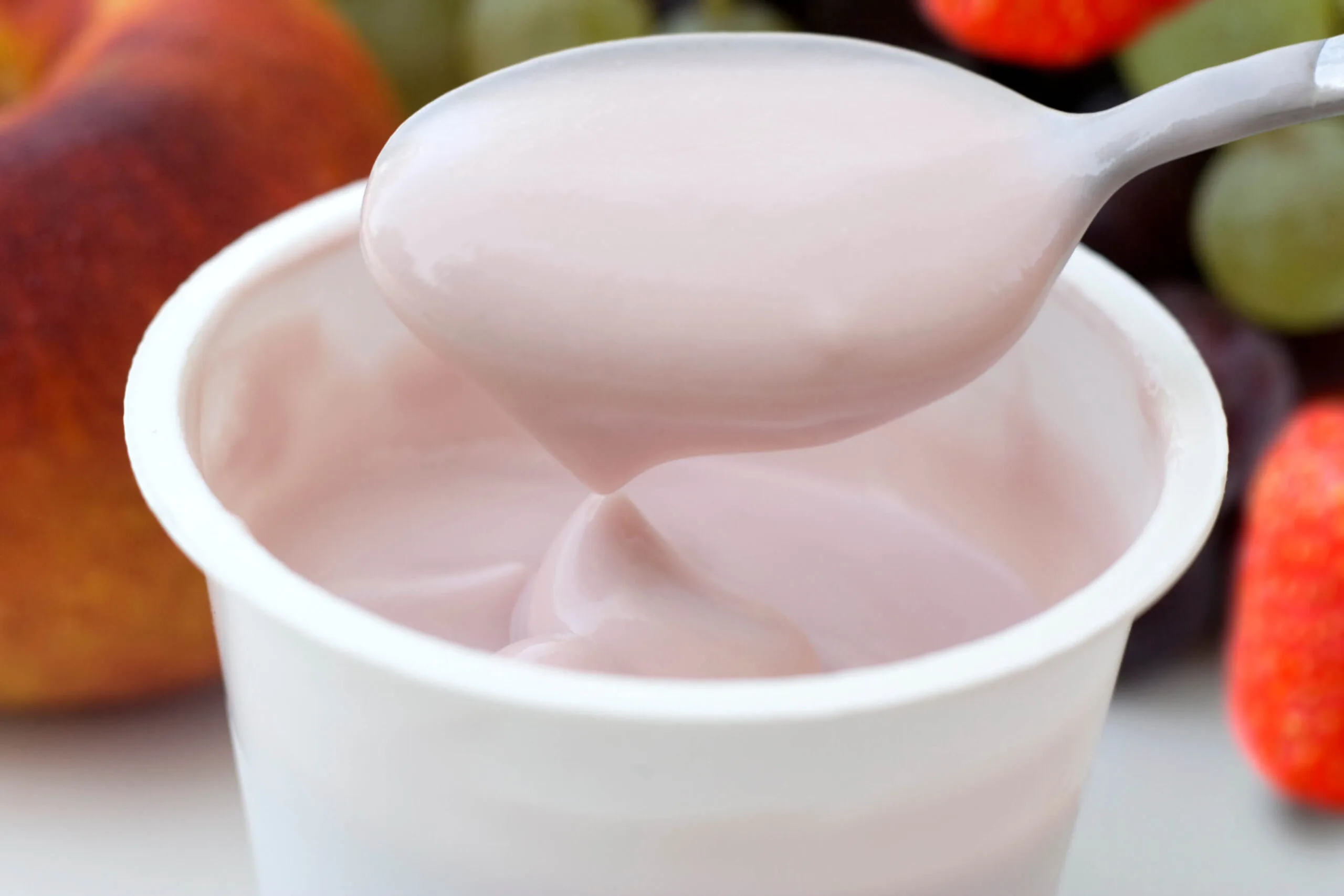 A white container of strawberry yoghurt
