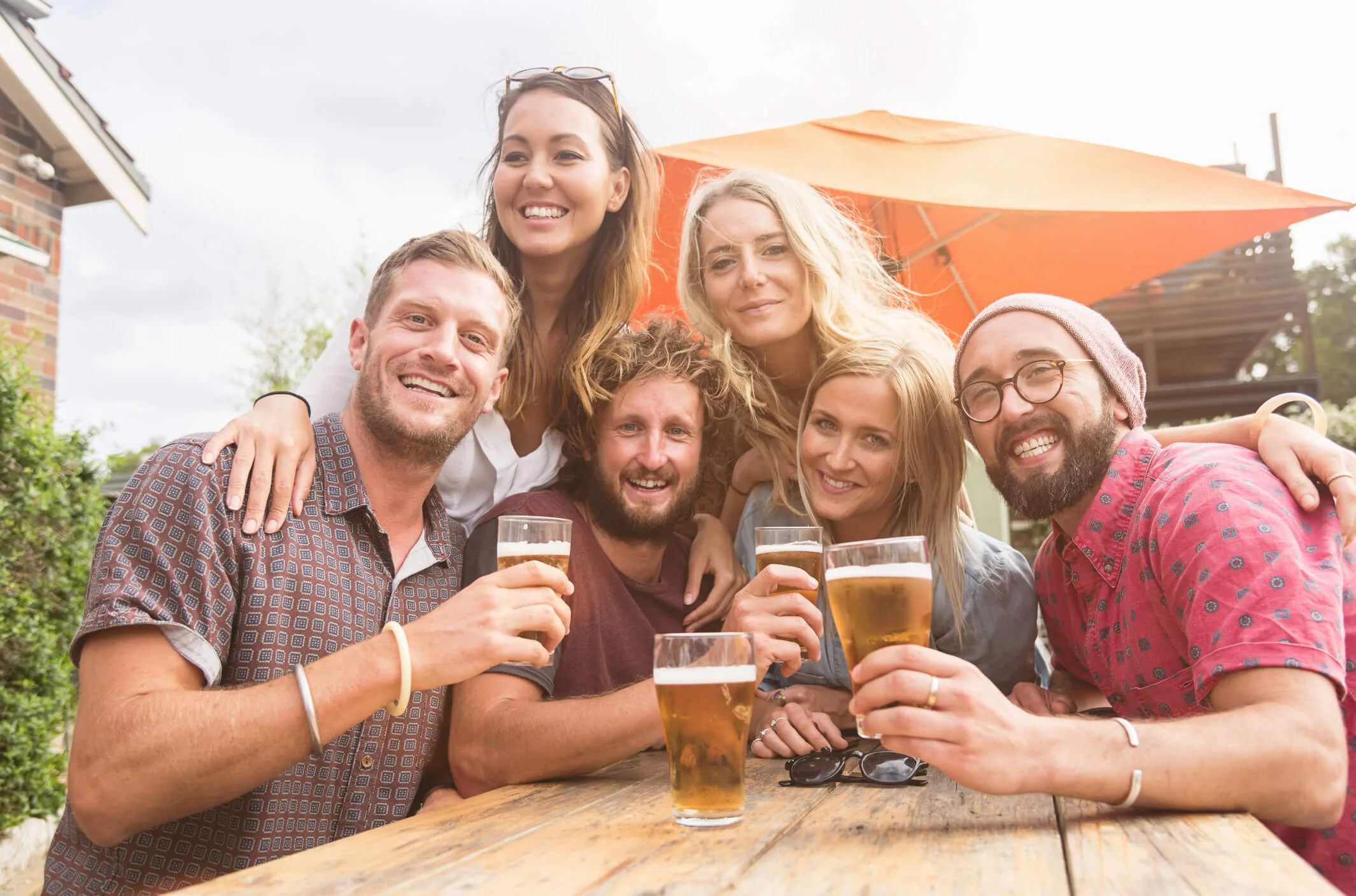 Friends drinking beer on an outside table