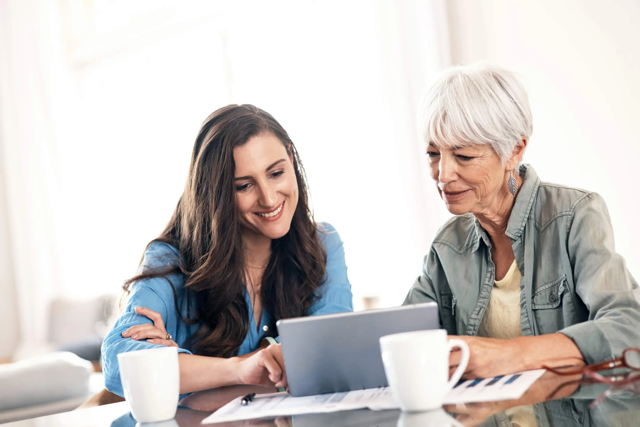 A woman helping her mother with her finances