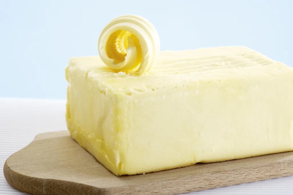 A block of butter on a wooden board