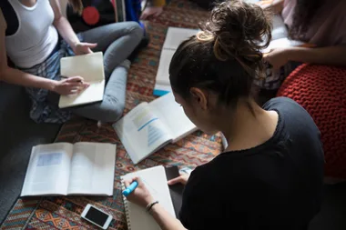 Students studying on the floor of a dorm room