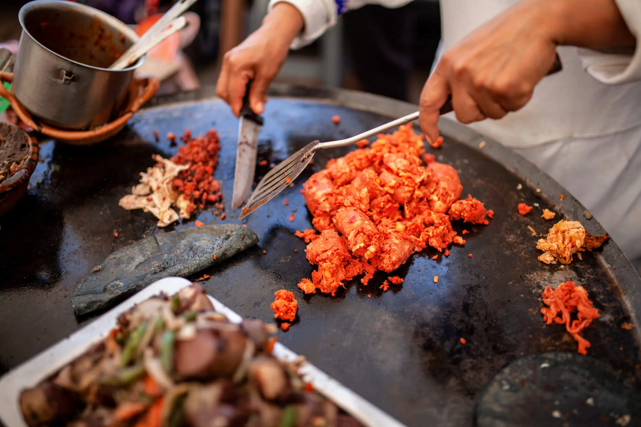 Chorizo sausage being cooked on a hotplate