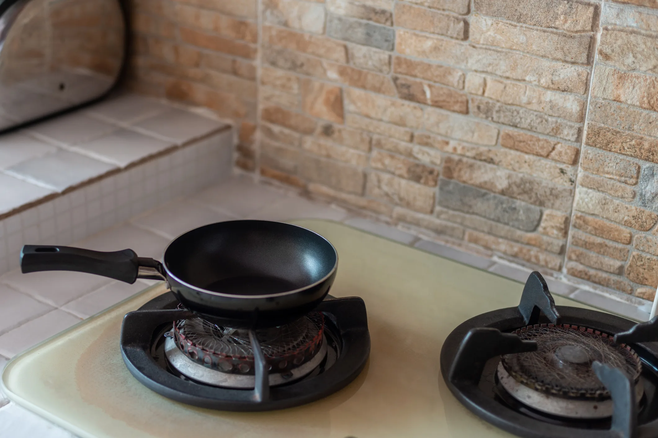A mini non stick fly pan on a stove top