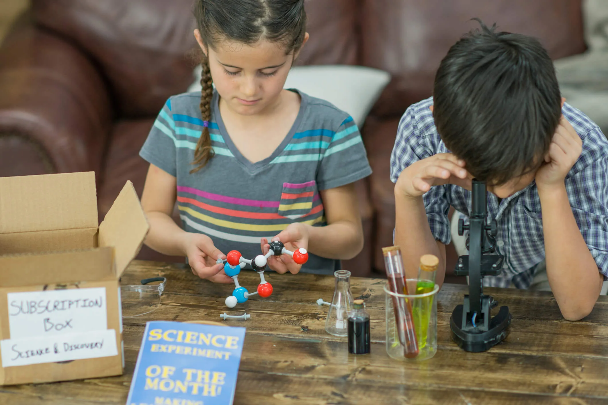 Kids playing with toys from a science subscription box