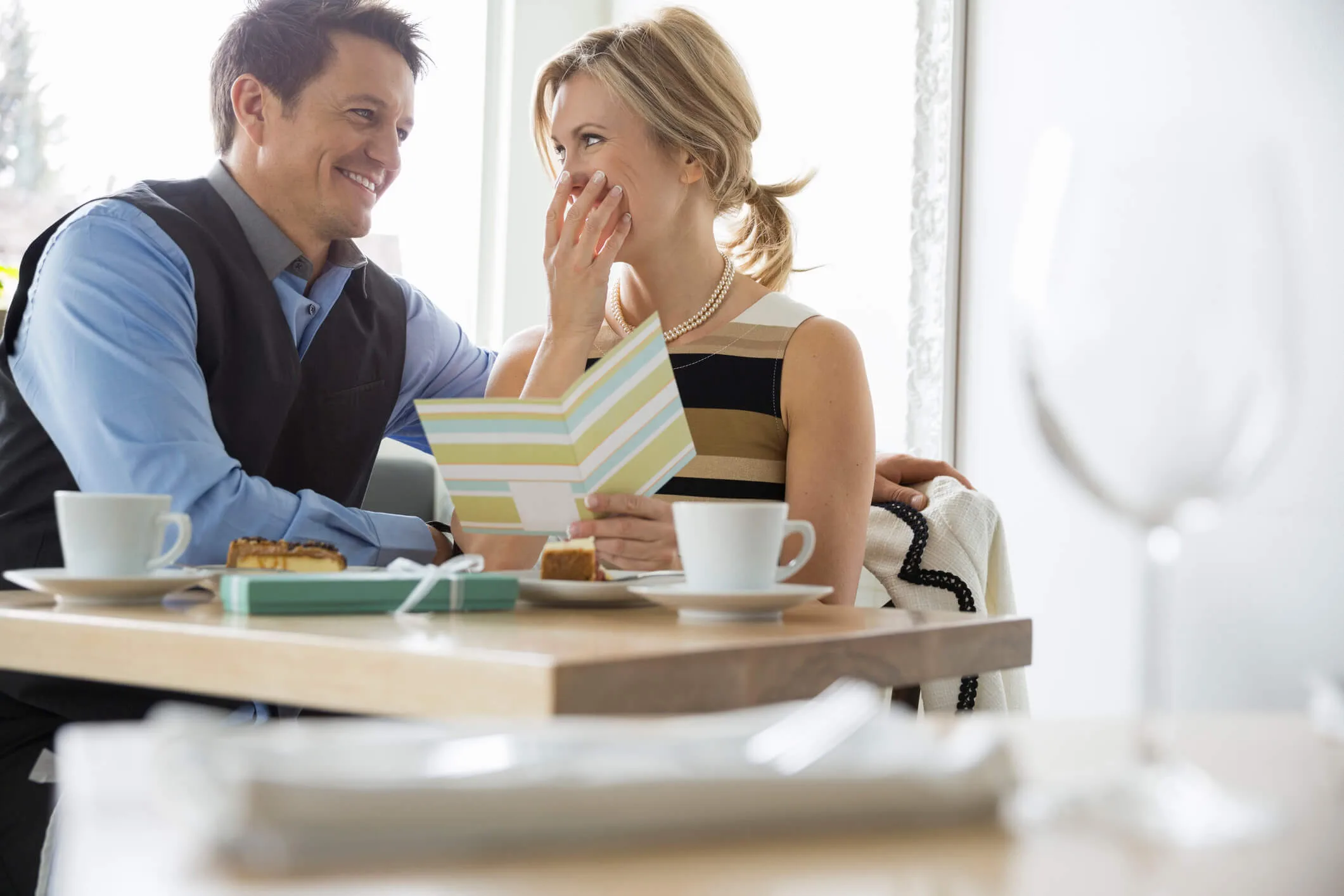 A surprised woman with a man at a bistro table