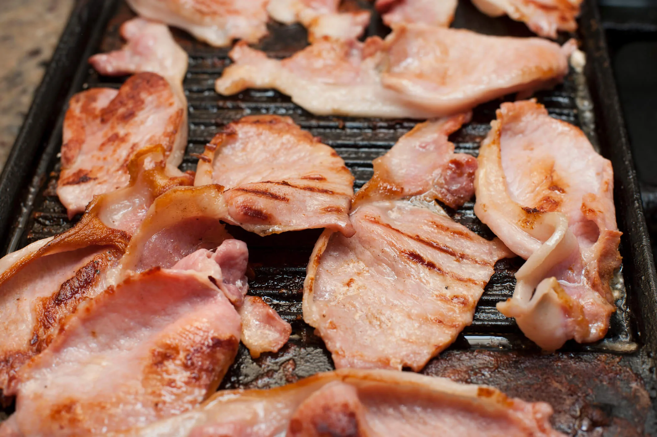 Bacon cooking on a barbecue