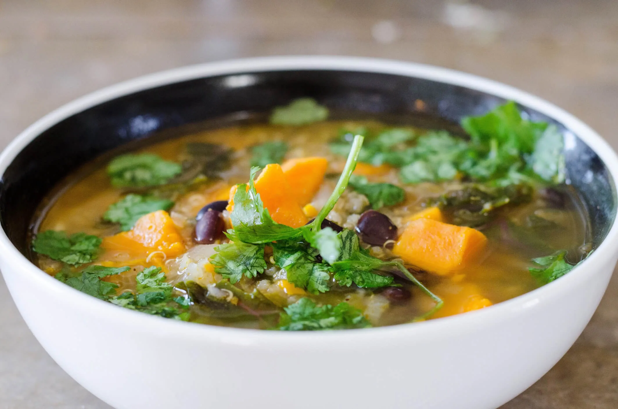 A close up shot of a bowl of vegetable soup