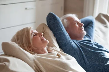 old couple relaxing on couch