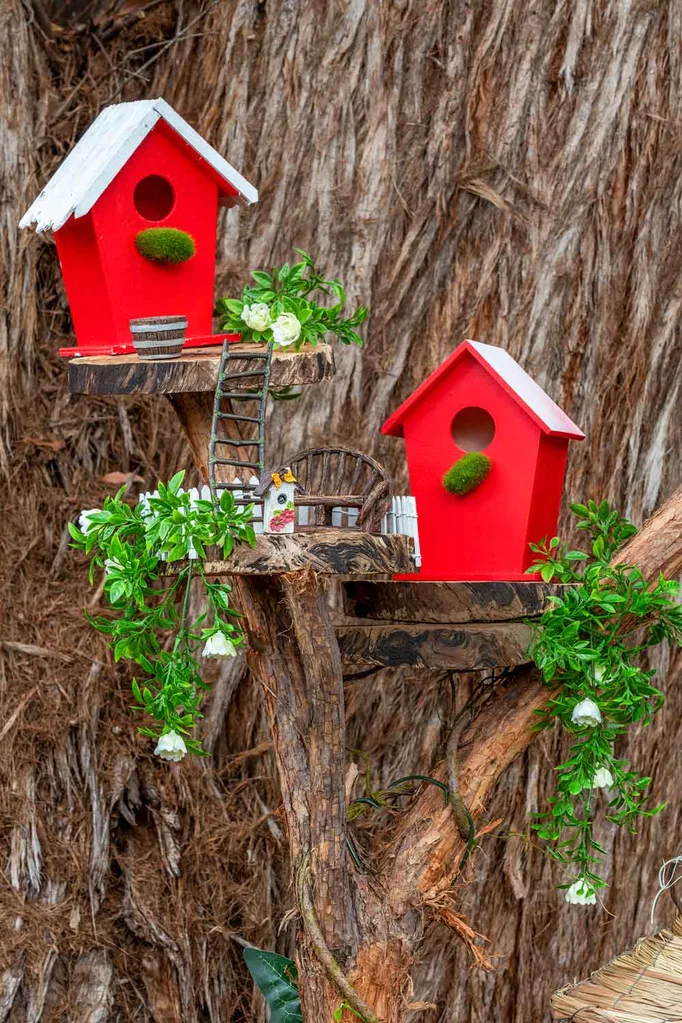 Painted birdhouses in a tree