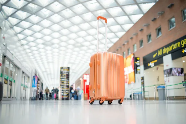 orange suitcase in airport