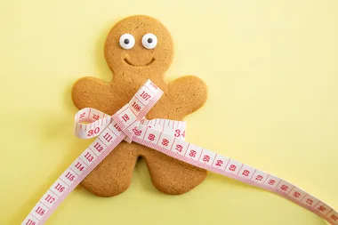 gingerbread man with measuring tape around waist