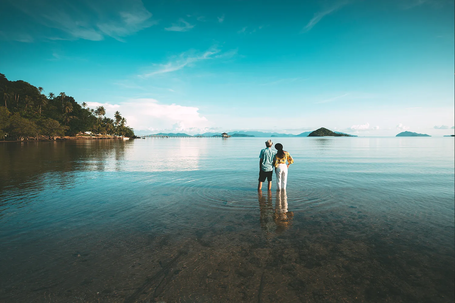 two people standing in a lake